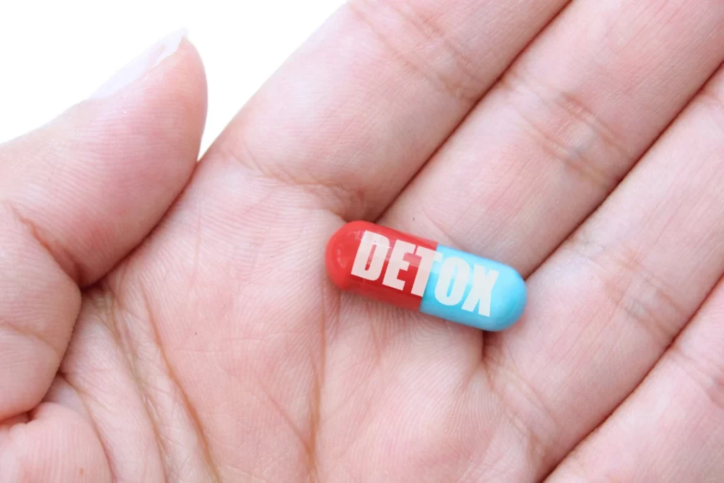 Detox pill in human hand.