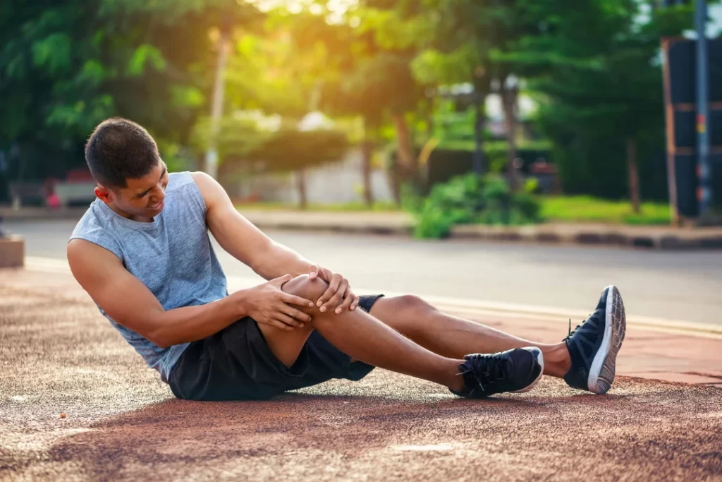 Young athlete suffering from muscle pain.