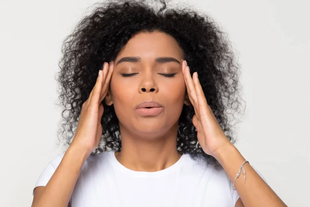 Nervous african woman breathing calming down trying to relieve stress