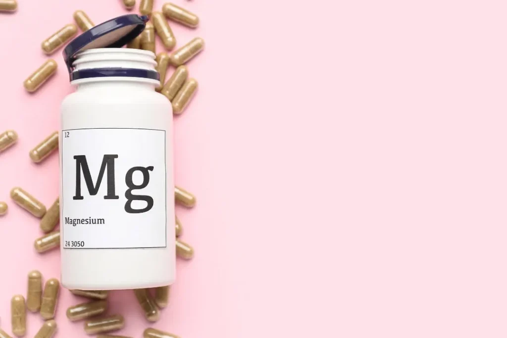 bottle with Magnesium pills with pink background