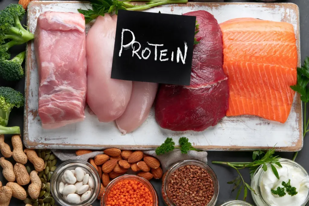 foods that contain protein and written protein on black paper