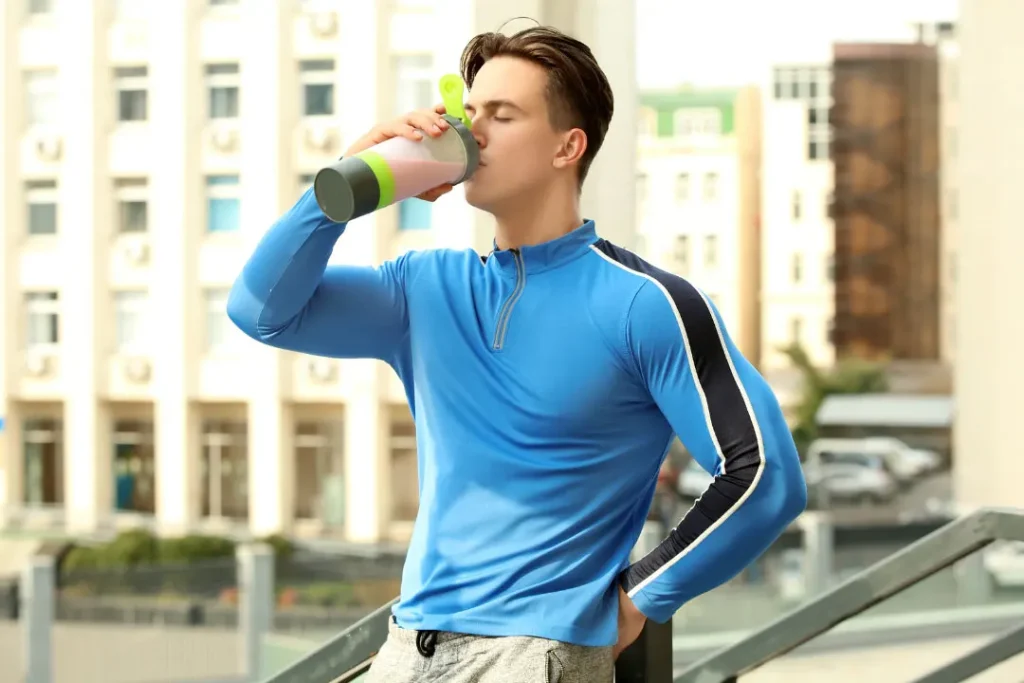 young man drinking a protein shake