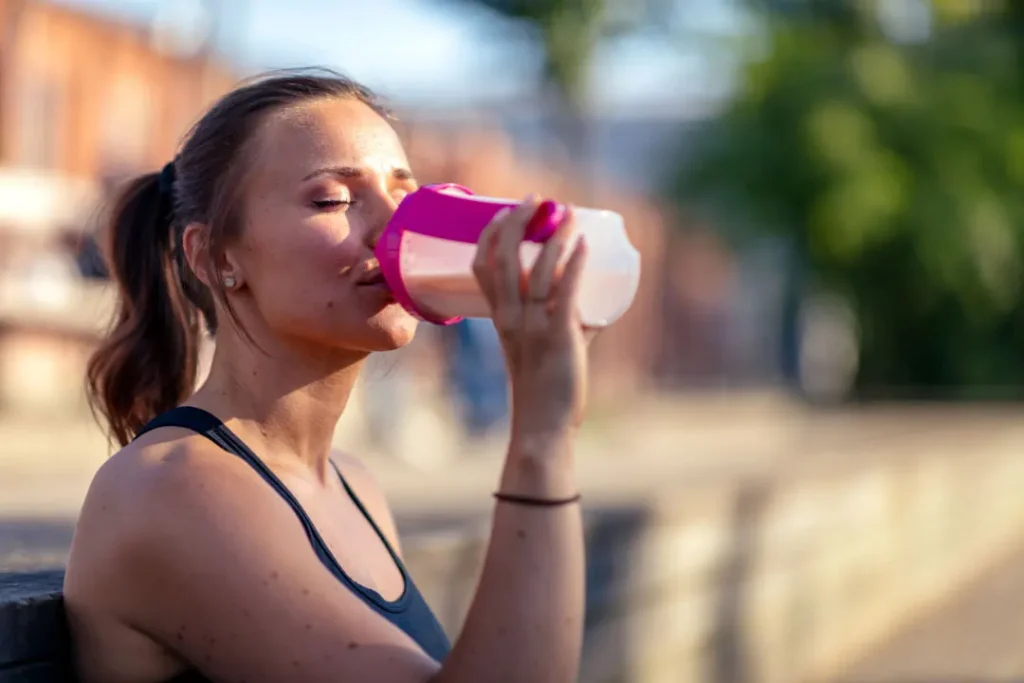 A girl drinking protein shake. 