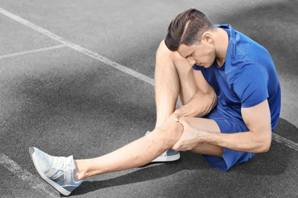 A player having cramps in his leg.