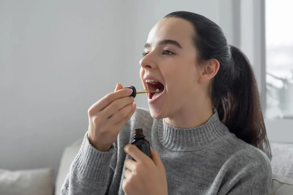 A young girl using CBD oil.