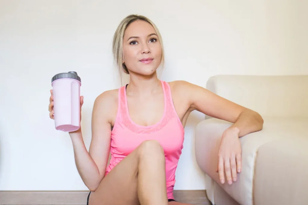 Lady having protein shake.
